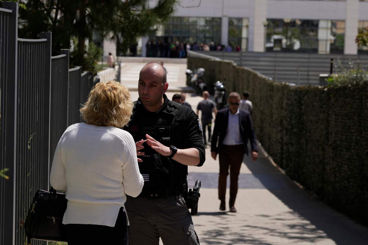 Policeman speaking to woman