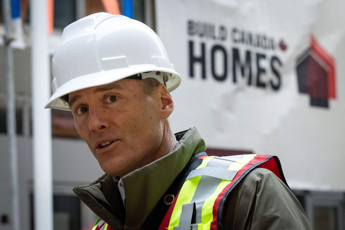 Minister of Housing and Infrastructure Gregor Robertson speaks after touring a housing development in Vancouver