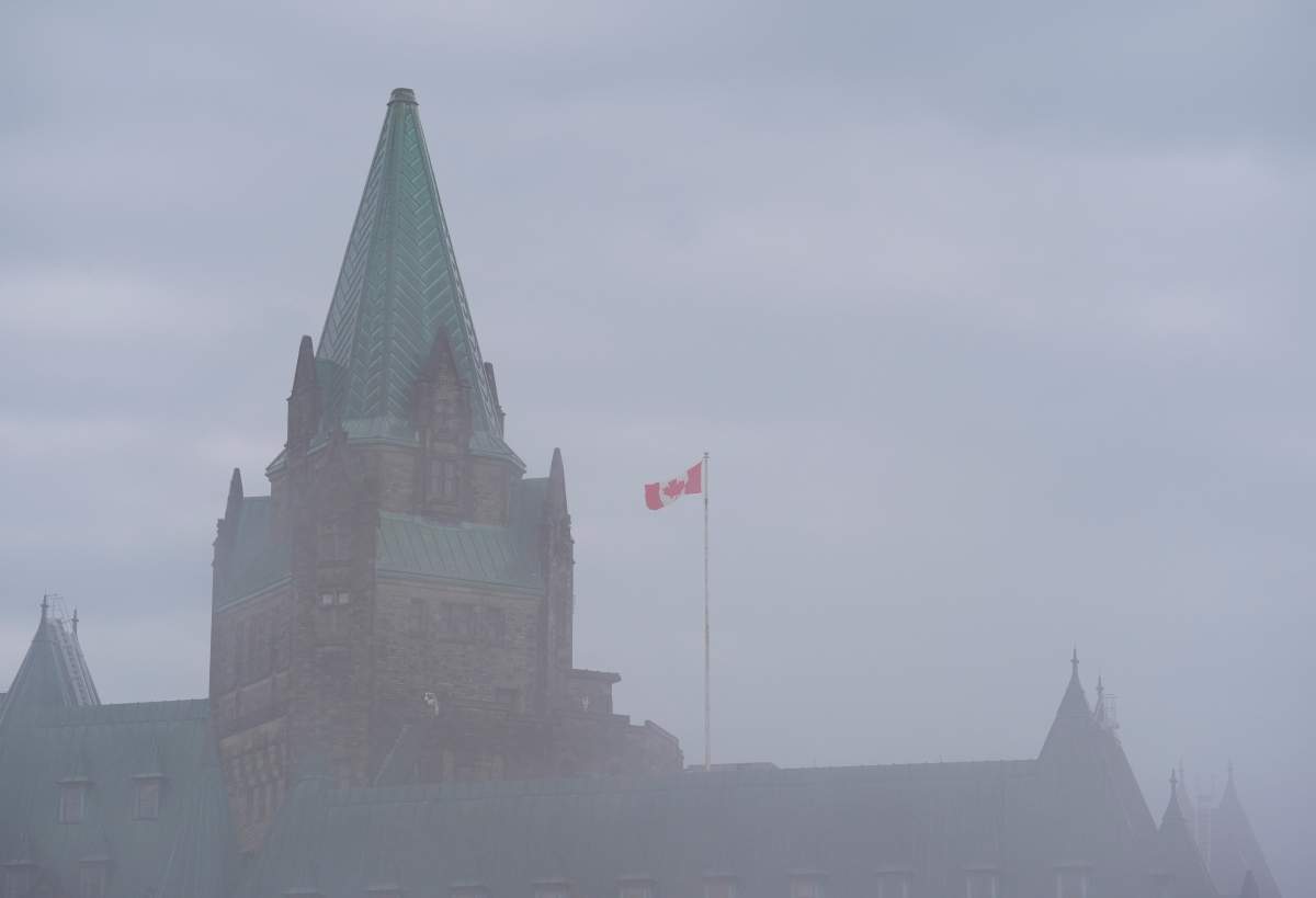 Fog shrouds the Confederation Building on Parliament Hill
