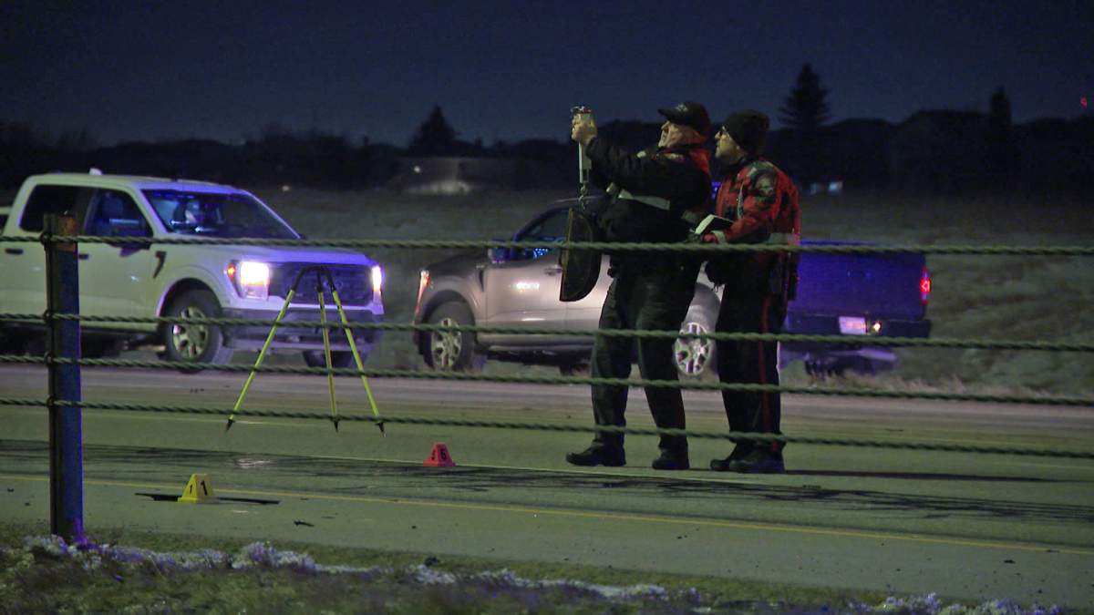 Calgary police have charged a man with dangerous driving after officers said he drove through a police barricade and the scene of a fatal crash early Wednesday morning while officers were still investigating.