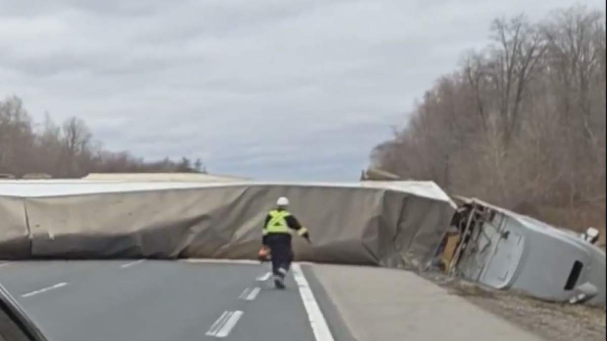 A transport truck sits on its side on Highway 403 eastbound in Oxford County after it collided with an SUV on Sunday, April 5, 2026. OPP say the drivers of both vehicles weren't injured.