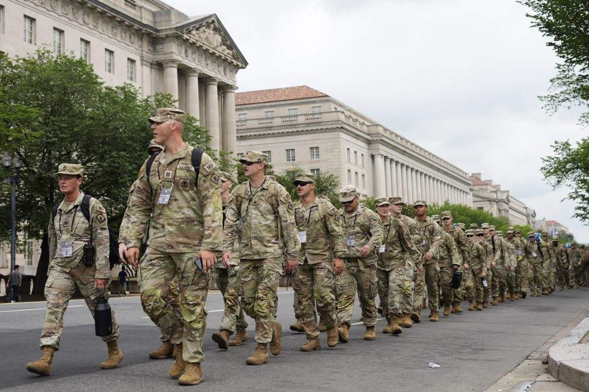 U.S. army soldiers walk along Constitution Avenue on the National Mall ahead of a parade commemorating the army's 250th anniversary and coinciding with President Donald Trump's 79th birthday, on June 14, 2025, in Washington. (AP Photo/Pablo Martinez Monsivais).