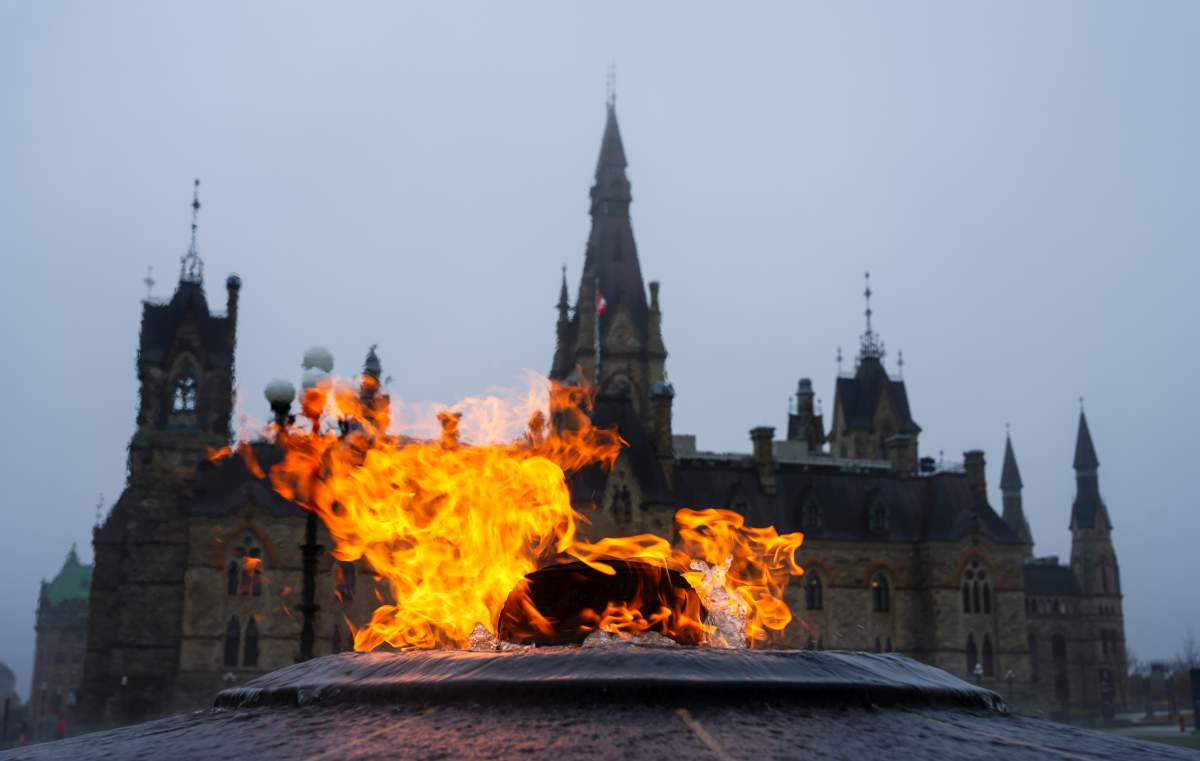 The West Block of Parliament Hill is pictured behind the Centennial Flame
