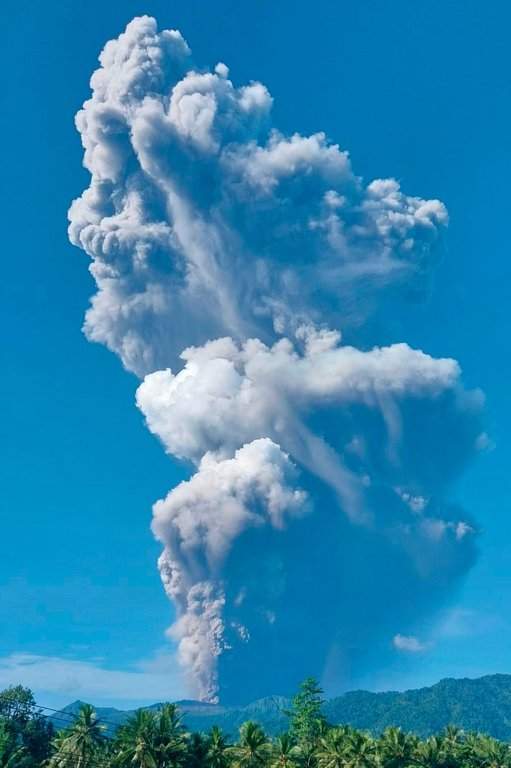 In this photo released by the Badan Geologi, the geological agency of Indonesia's Ministry of Energy and Mineral Resources, Mount Dukono releases volcanic materials during an eruption in North Halmahera, Indonesia, Friday, May 8, 2026.