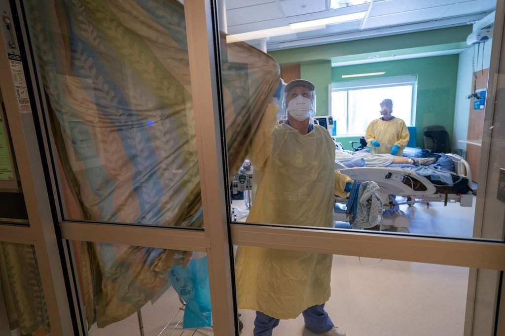 Nurses close the curtains of a patients room in the Intensive Care Unit at Surrey Memorial Hospital in Surrey, B.C., Friday, June 4, 2021. 