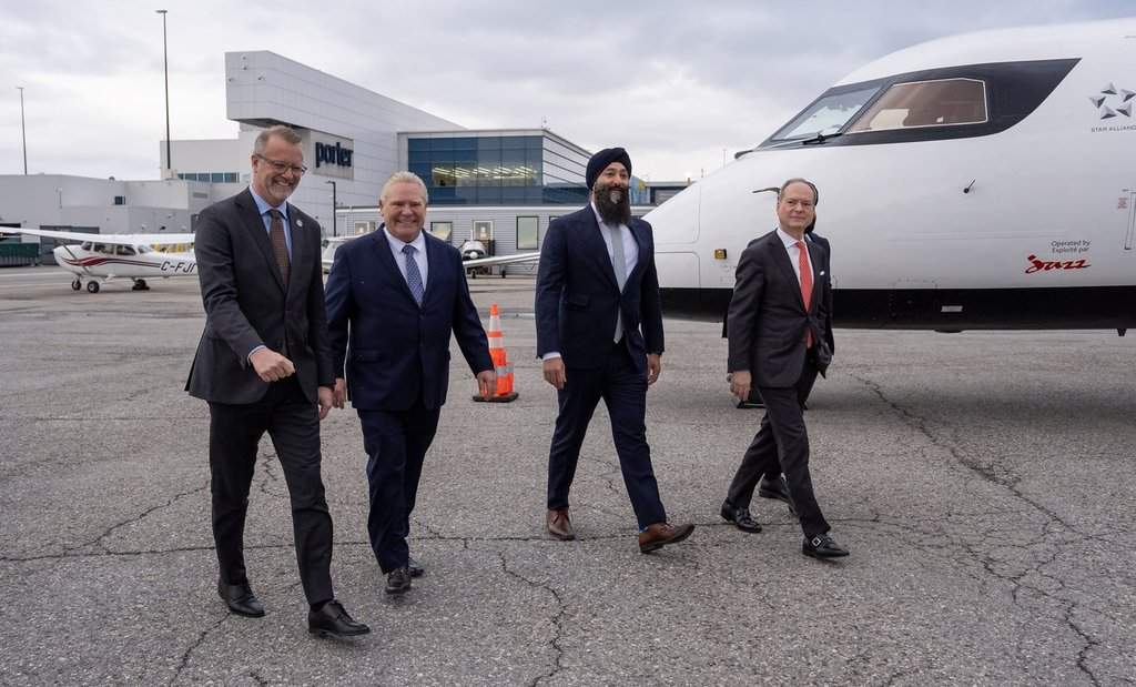 Toronto Port Authority President and CEO RJ Steenstra, left to right, Ontario Premier Doug Ford, Ontario Transportation Minister Prabmeet Singh Sarkaria and Ontario Finance Minister Peter Bethlenfalvy arrive at an event at Billy Bishop Toronto City Airport on Monday March 23, 2026. 