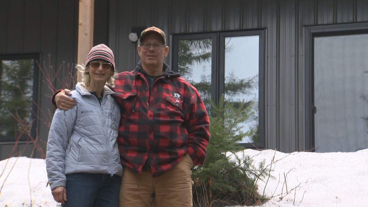 Pat and Russ Popp in front of their home on Bird Lake.