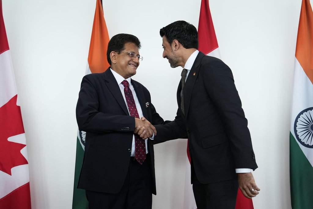 Minister of International Trade Maninder Sidhu, right, and India's Minister of Commerce and Industry Piyush Goyal shake hands before a bilateral meeting in Ottawa on Monday, May 25, 2026. THE CANADIAN PRESS/Justin Tang.