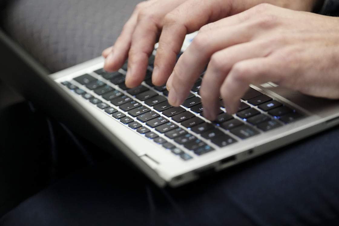 A person types on a laptop computer during an artificial intelligence roundtable attended by AI experts and leaders from across Canada in Gatineau, Que., on Monday, May 27, 2024.
