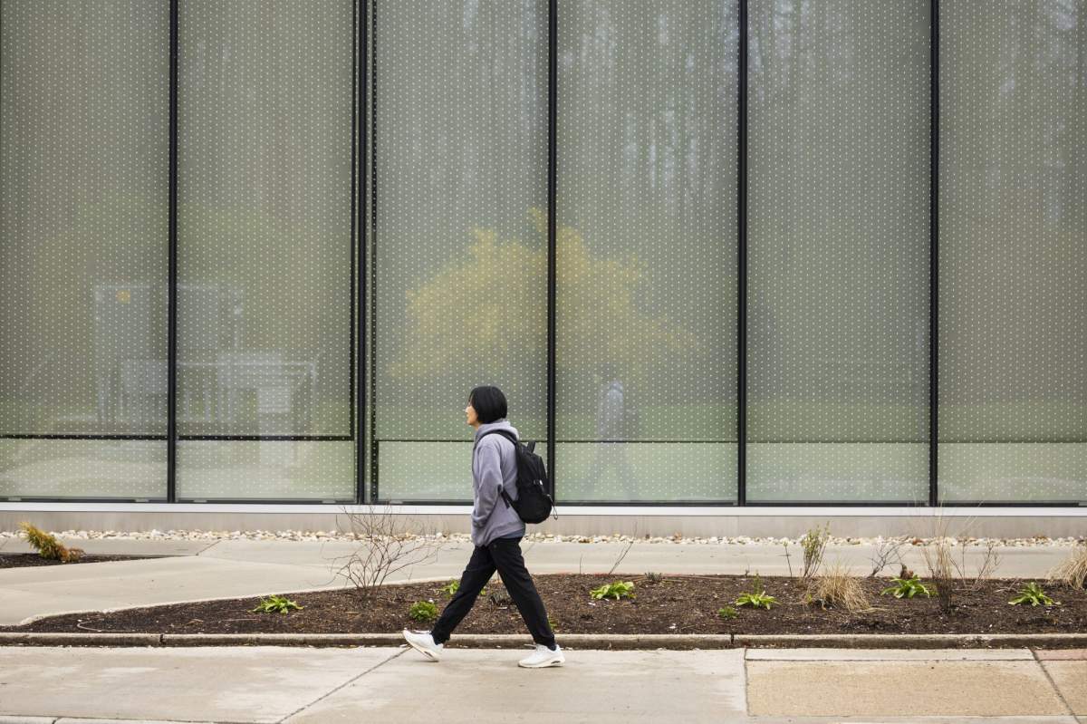 A student walks on the Conestoga College campus in Kitchener, Ont., Saturday, April 27, 2024. The main campus of Conestoga College has been experiencing an explosion of international students because of aggressive recruitment. 