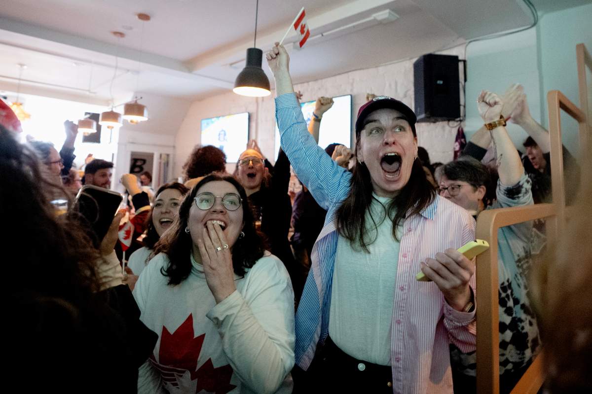Fans at Le Nadia sports café in Montreal celebrate the Canadian Olympic women’s hockey team after they scored during first period of the gold medal game between Canada the United States, at the 2026 Milan Winter Olympics, on Thursday, Feb, 19 2026. THE CANADIAN PRESS/Christopher Katsarov