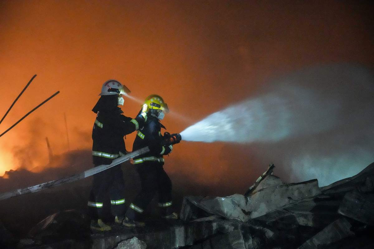 In this photo released by Xinhua News Agency, firefighters work to out the fire after an explosion at a fireworks plant in Guandu Town of Liuyang, central China's Hunan Province, in the early hours of May 5, 2026.