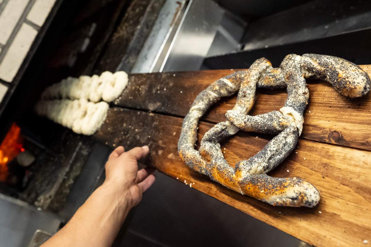 A bagel in the shape of the Montreal Canadiens logo is taken out of the oven after baking at St-Viateur Bagel in Montreal, on Thursday, May 7, 2026. THE CANADIAN PRESS/Christopher Katsarov