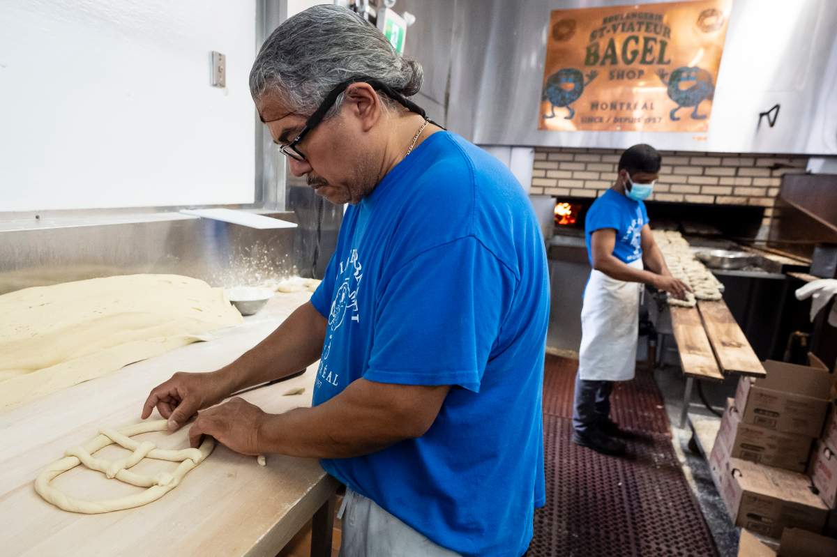 A bagel in the shape of the Montreal Canadiens logo is shaped by baker Pedro Benitez at St-Viateur Bagel in Montreal on Thursday, May 7, 2026. THE CANADIAN PRESS/Christopher Katsarov