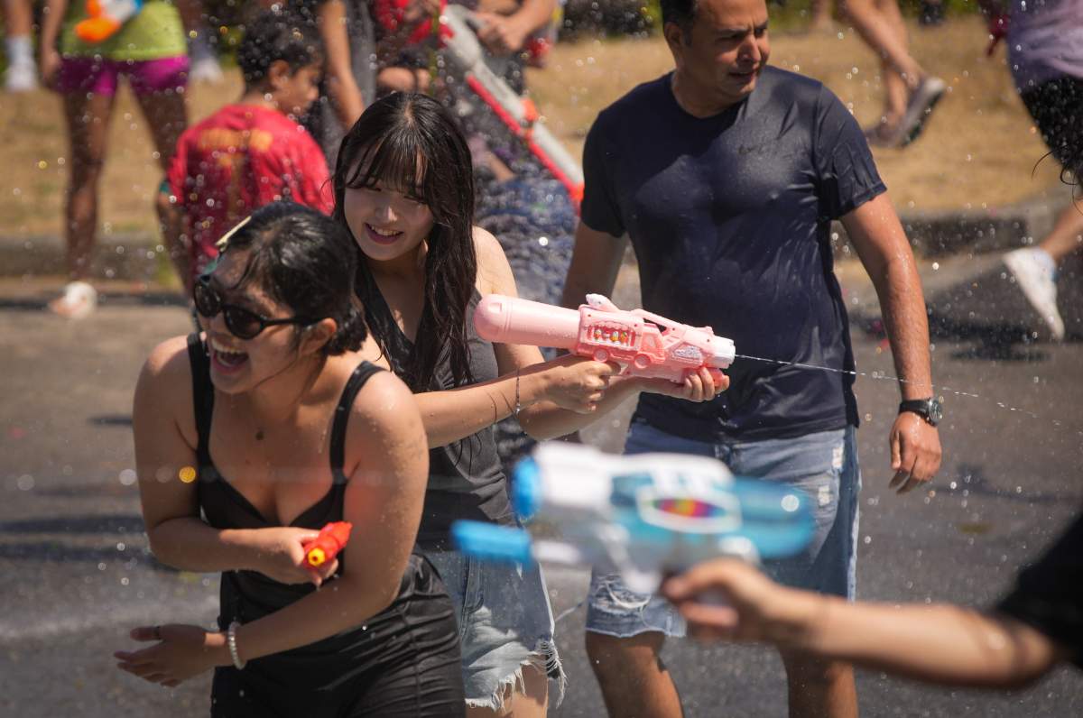 People tease each other with water guns during the flash mob-style water fight at Stanley Park in Vancouver, British Columbia, Canada, on Aug. 9, 2025. (Credit Image: © Liang Sen/Xinhua via ZUMA Press).