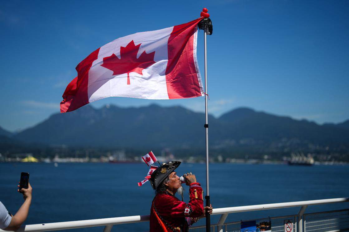 Dressed as a patriotic pirate, Hobes Hernandez Osorto, drinks a Molson Canadian beer while holding a Canadian flag during Canada Day festivities in Vancouver, on Tuesday, July 1, 2025. THE CANADIAN PRESS/Darryl Dyck