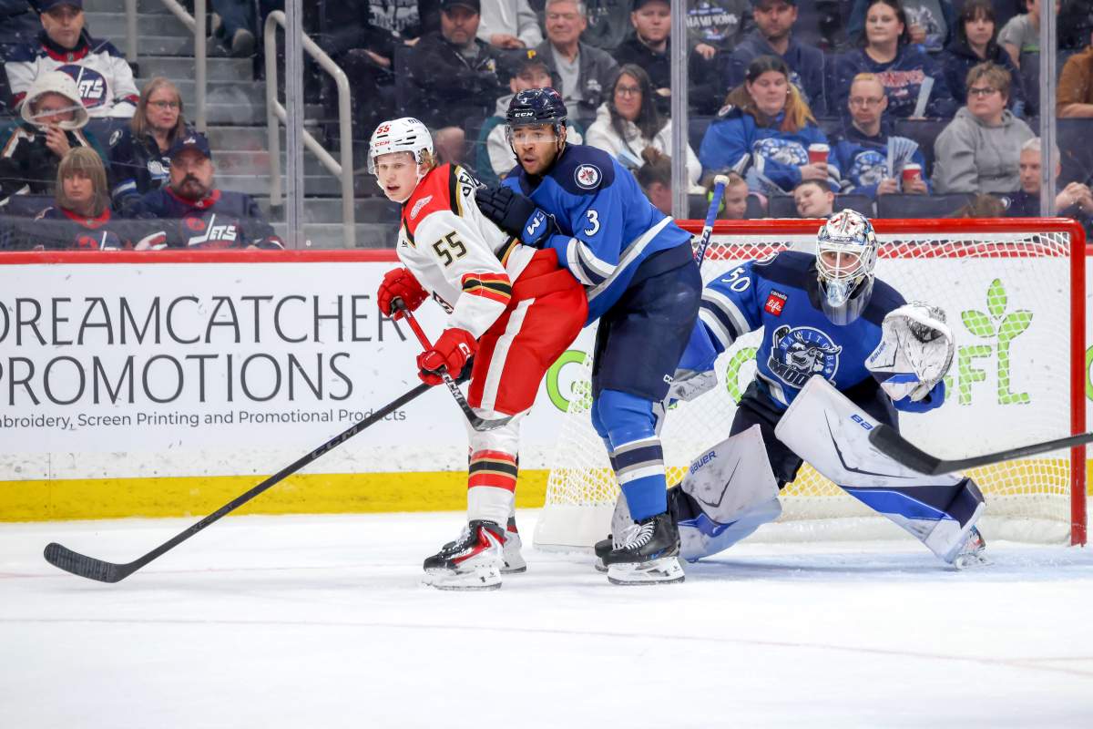Manitoba Moose Defenseman Isaak Phillips ties up Grand Rapids Forward Eddie Genborg in front of Goalie Dominec DiVincentiis May 4/26.