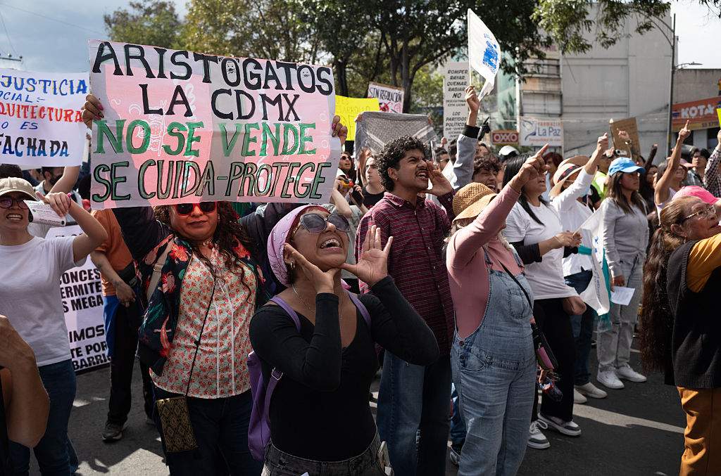 Demonstrators march during a protest against gentrification and tourism in the Tlalpan neighborhood of Mexico City, Mexico, on Sunday, July 20, 2025. Mexico City's government presented a plan to fight gentrification following a recent protest from citizens that accused foreigners moving into the capital of making it more expensive and displacing longtime residents and merchants.