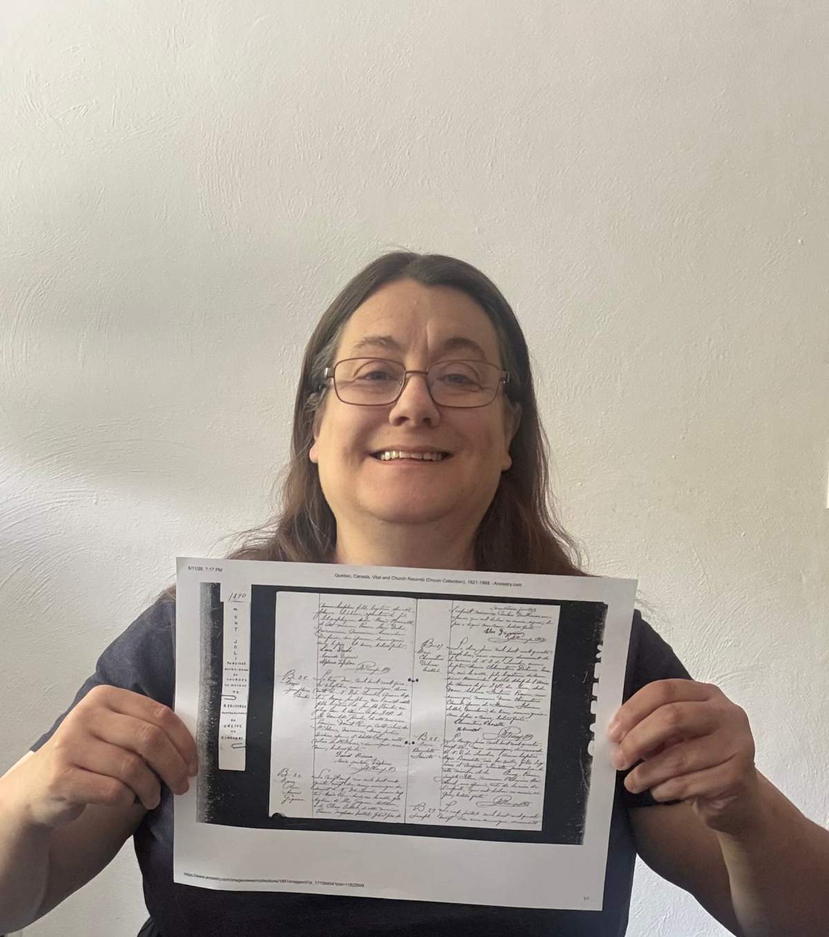 Maria Dutilly from Pittsburgh holds up a record of her great-grandmother Josephine Berube's birth in Canada in this undated handout photo.