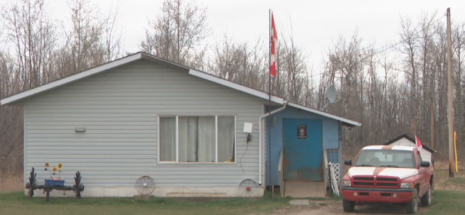 Canada flags fly from a home and a truck on Sturgeon Lake Cree Nation on May 6, 2026.
