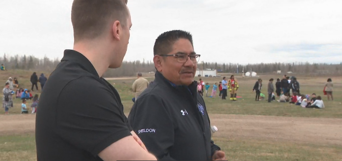 Sturgeon Lake Cree Nation chief Sheldon Sunshine stands among a group of children outside Sturgeon Lake Cree Nation school on May 6, 2026.