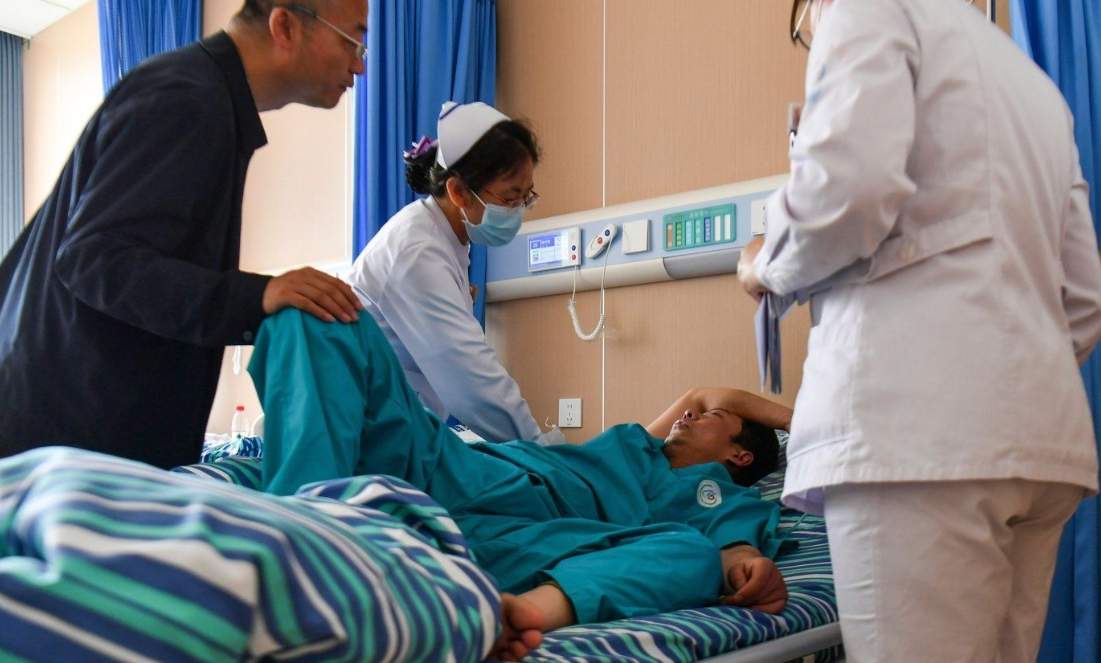In this photo released by Xinhua News Agency, medical staff attend to an injured worker at a hospital in the aftermath of an explosion at Changzhi city's Liushenyu coal mine in Qinyuan county, northern China's Shanxi Province on Saturday, May 23, 2026. 
