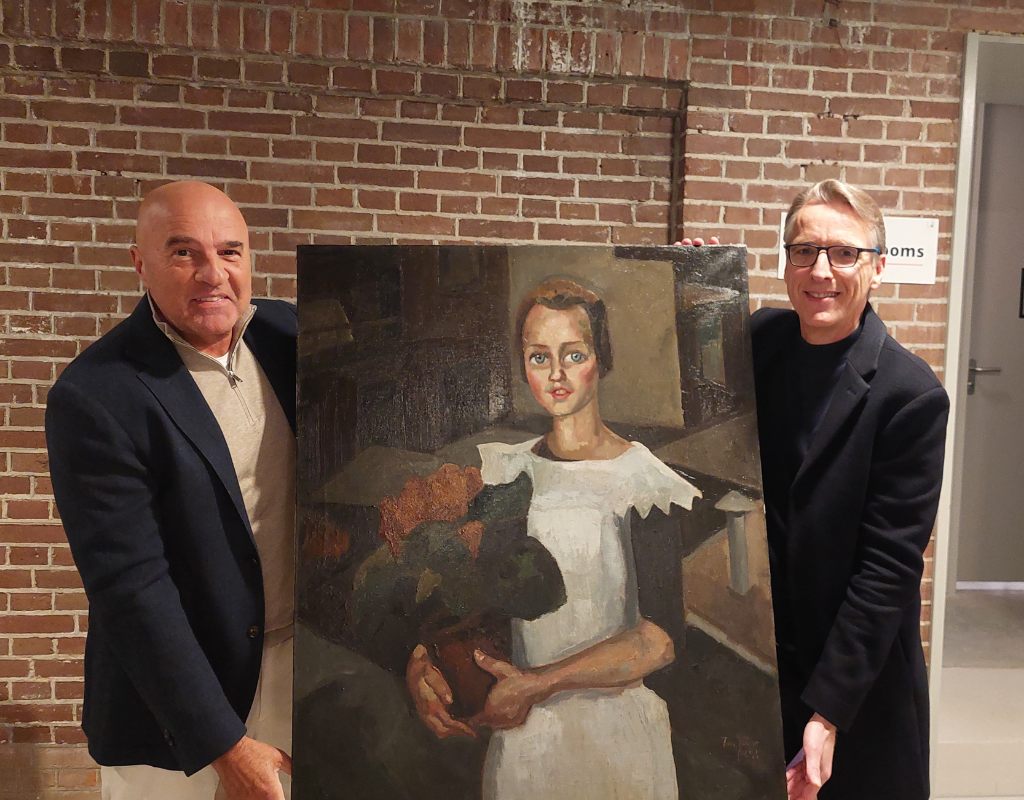 Left to right: A Dutch journalist and art detective Arthur Brand pose with a recovered painting looted by the Nazis.