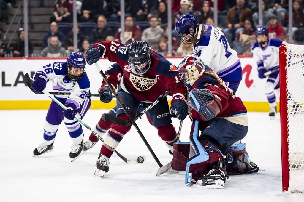 Montreal Victoire goaltender Ann-Renee Desbiens (35) makes a save on Minnesota Frost's Kendall Coyne Schofield (26) while Victoire's Hayley Scamurra (16) defends, during first period PWHL playoff hockey action in Laval, Que., on Tuesday, May 12, 2026. 