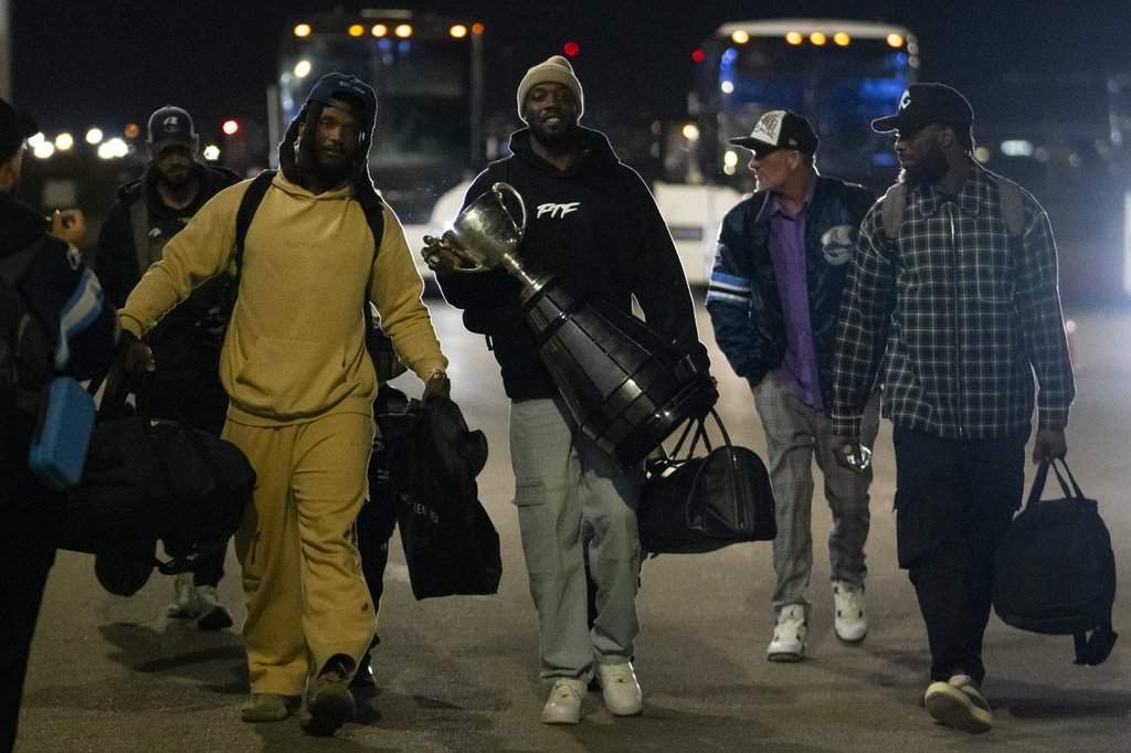 Toronto Argonauts wide receiver DaVaris Daniels carries the Grey Cup while walking alongside his teammates as they arrive at Toronto Pearson International Airport in Mississauga, Ont., Monday, Nov. 18, 2024. The Argonauts defeated the Winnipeg Blue Bombers on Sunday to win the cup. THE CANADIAN PRESS/Arlyn McAdorey.