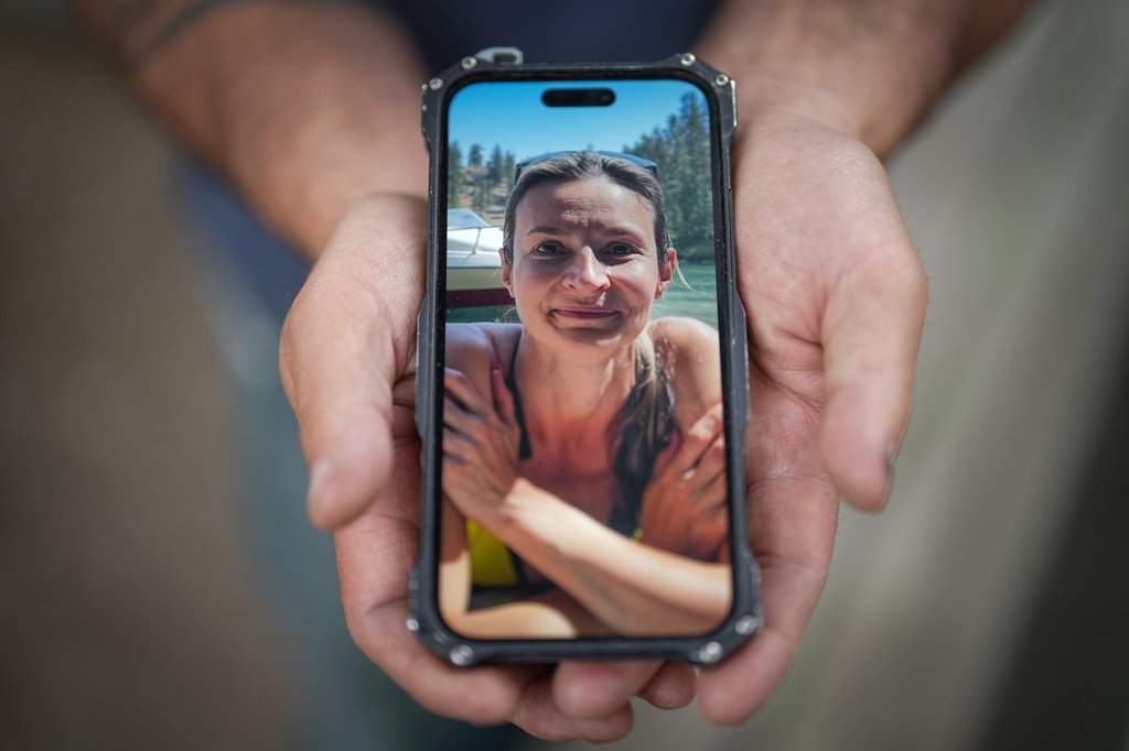 Jason Gaudreault, whose partner Tatjana Stefanski was found dead on April 14, 2024, after disappearing a day earlier, shows a photograph of her on his phone, in Lumby, B.C., on Monday, May 13, 2024. 