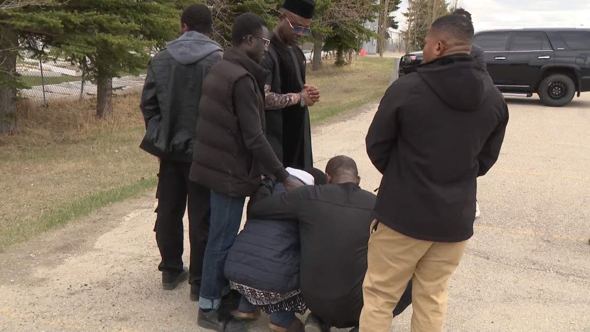 Damilola's father, Jabreel Afolabi (centre) was so overcome with grief during his son's funeral that he had to be comforted by friends.
