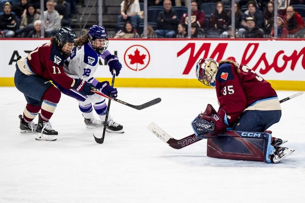 Montréal Victoire goaltender Ann-Renée Desbiens (35) makes a save against Minnesota Frost's Kelly Pannek (12) while the Victoire's Abby Roque (11) defends, during second overtime period PWHL playoff hockey action in Laval, Que., on Tuesday, May 5, 2026. 