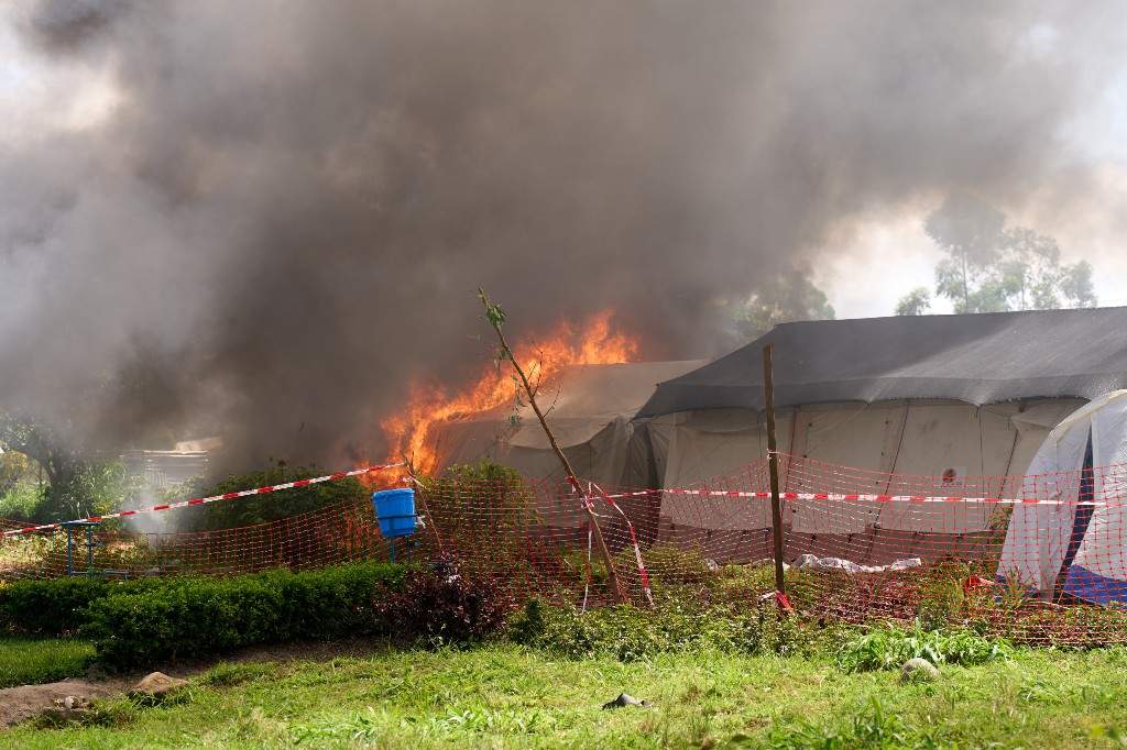 Flames and smoke rise from an Ebola treatment centre in Rwampara, Congo, Thursday, May 21, 2026.