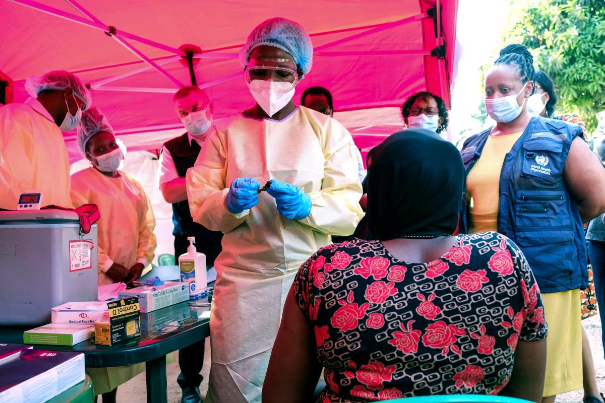 FILE: A health worker prepares to administer a vial of a vaccine against the Sudan strain of Ebola, during a trial, at Mulago Referral Hospital, in Kampala, Uganda Monday, Feb. 3, 2025.