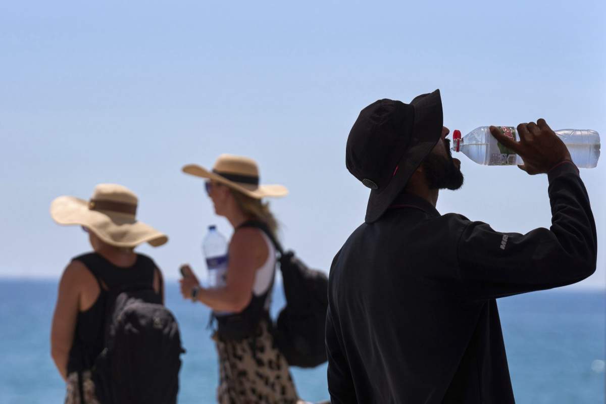 A tourist drinks water