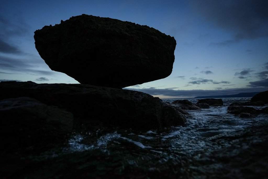 Balance Rock is silhouetted at dusk in Skidegate, B.C., on Haida Gwaii, Monday, Feb. 17, 2025. THE CANADIAN PRESS/Darryl Dyck.