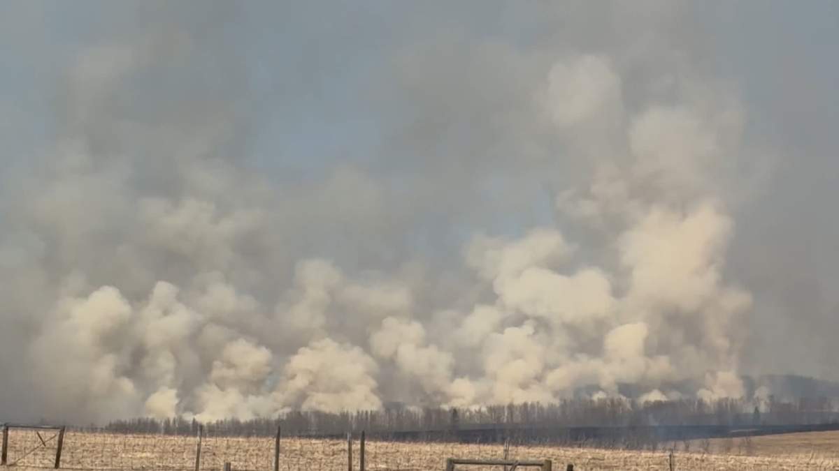 The rapidly growing fire on Thursday forced fire crews from Rocky View County to call for help from several other neighbouring fire departments.