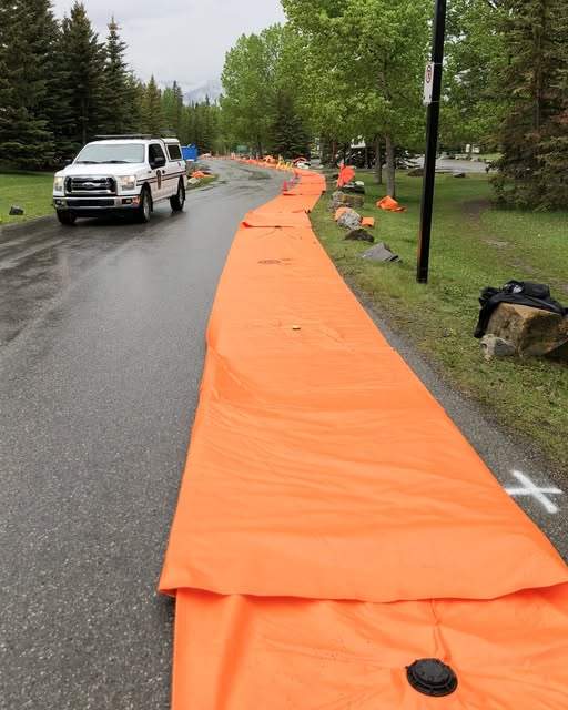 The town of Banff readies for the possibility of flooding by setting up temporary flood barriers.