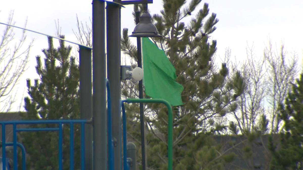 A green flag could be seen flying over the beach at Mahogany Lake on Tuesday, signifying the lake was safe for swimming.