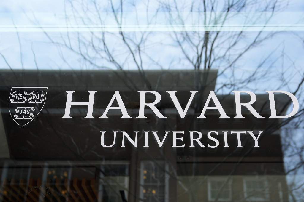 The Harvard University logo is displayed on a building at the school, Tuesday, April 15, 2025, in Cambridge, Mass.