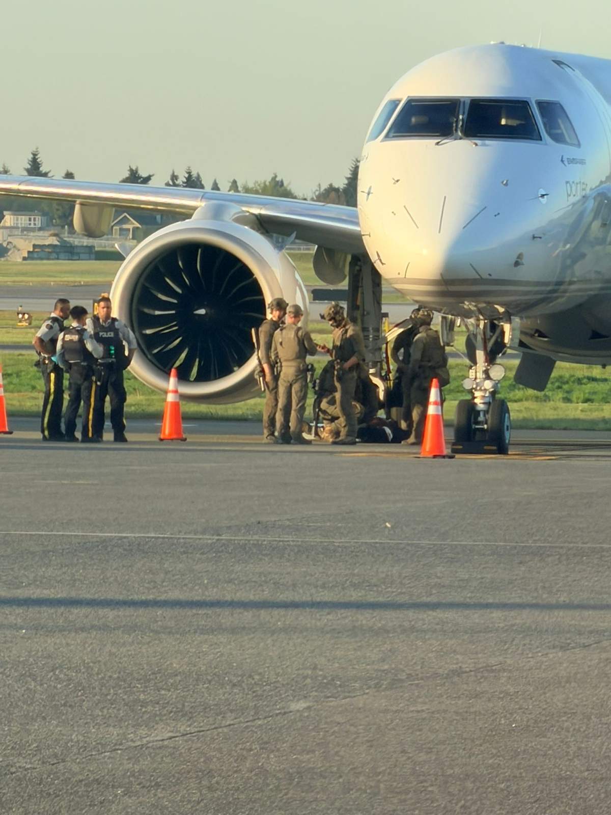 RCMP and security officials on a runway at Vancouver's International Airport on Monday morning.