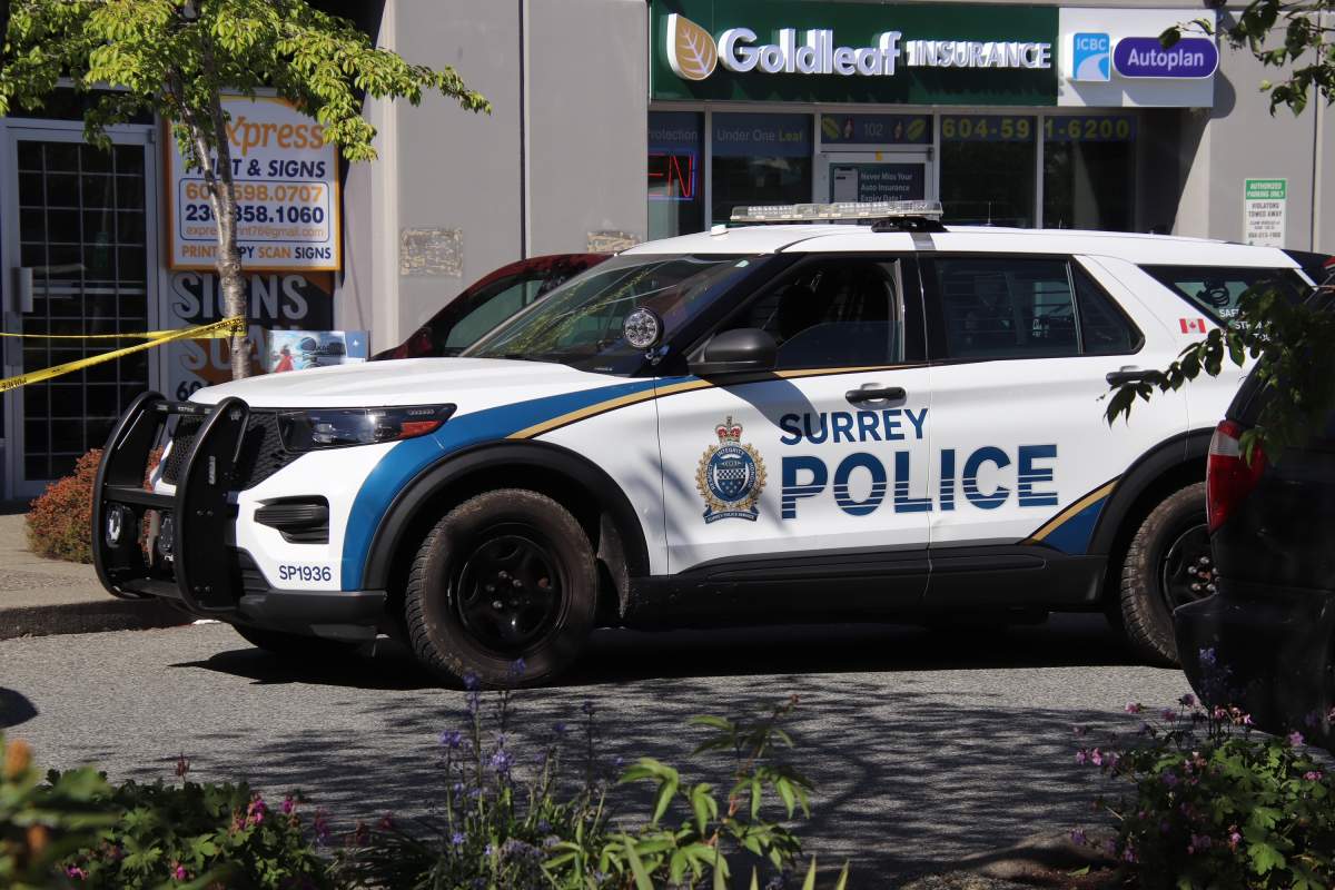 Surrey police officers on the scene following a fatal shooting on Monday afternoon.