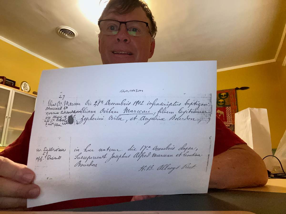 Jeffrey Lensman from Salt Lake City, Utah, holds a copy of his grandfather's baptismal record in this undated handout photo. Lensman is seeking Canadian citizenship on the basis of a great-great-grandfather born in Quebec in 1838.