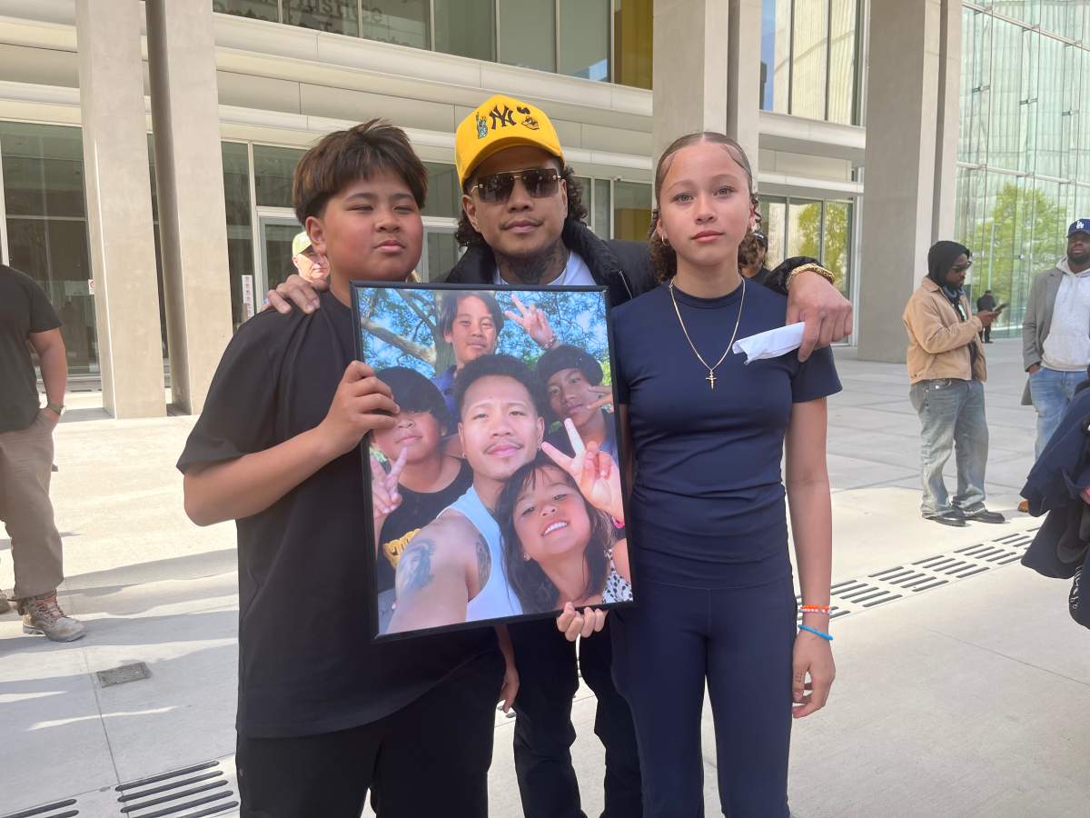 Avery Lavina, left, stands next to his father Maverick Lavina. Avery survived a fatal crash that killed his three siblings.