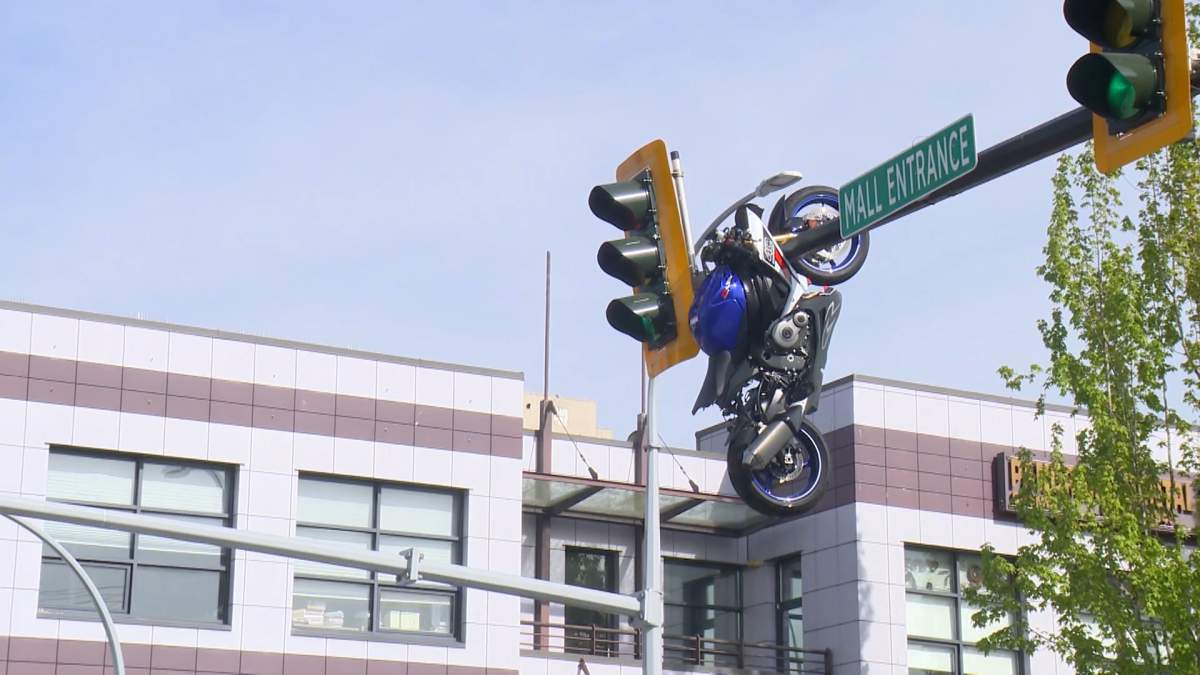 A motorcycle hangs on a streetlight in Delta, B.C. on Saturday, May 9, 2026 after it was involved in a collision.
