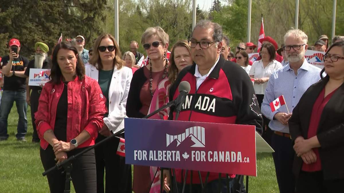 Alberta NDP Leader Naheed Nenshi, speaks at a pro-Canada rally of party members in Calgary on May 22, alongside former Olympian Catriona Le May Doan.