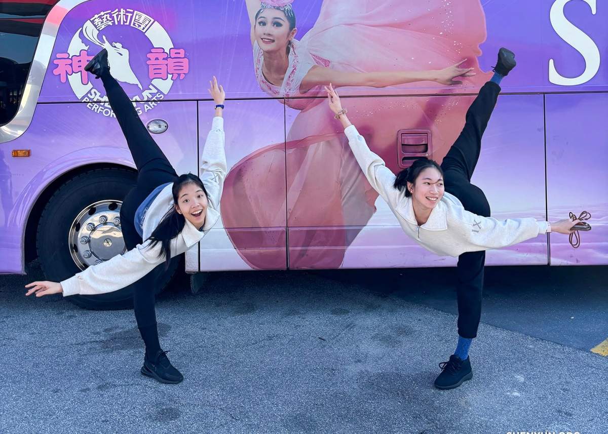 Shen Yun dancers pose with their tour bus.