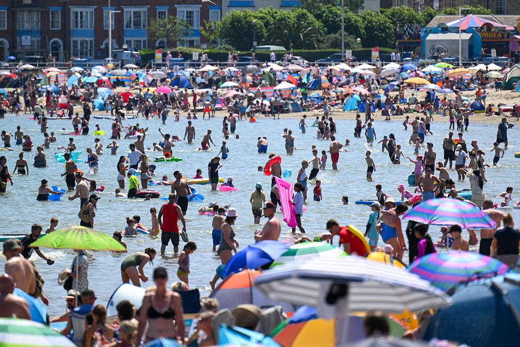 WEYMOUTH, ENGLAND - MAY 24: Crowds of visitors are seen at the beach, on May 24, 2026 in Weymouth, England. An exceptional bank holiday heatwave is currently bringing record-breaking weather to England with temperatures forecast to climb into the low 30s by Monday. The intense high pressure has prompted the UK Health Security Agency (UKHSA) to issue rare, amber heat alerts across multiple regions due to the health risks for vulnerable people and extreme UV levels.