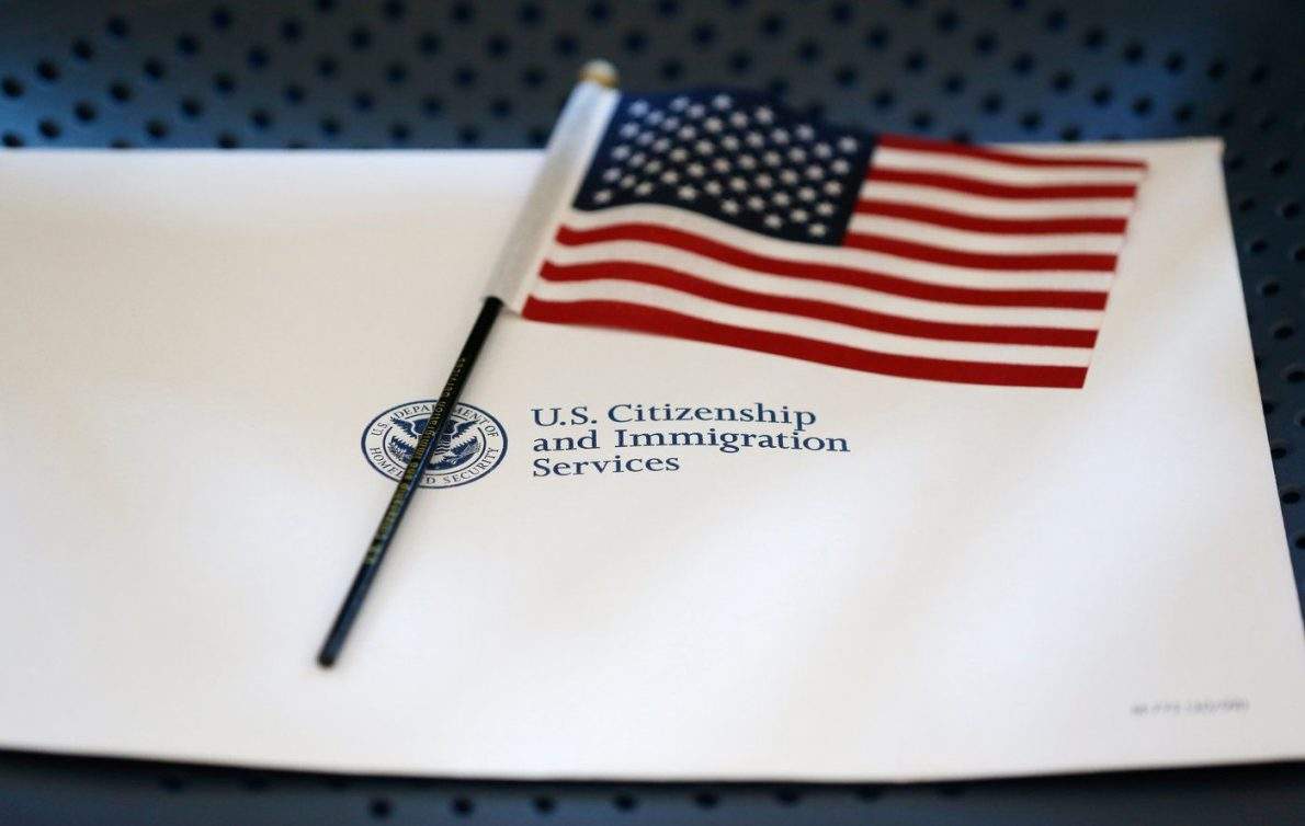 FILE - An information packet and an American flag are placed on a chair at the U.S. Citizenship and Immigration Services Miami Field Office on Aug. 17, 2018, in Miami. (AP Photo/Wilfredo Lee, File).