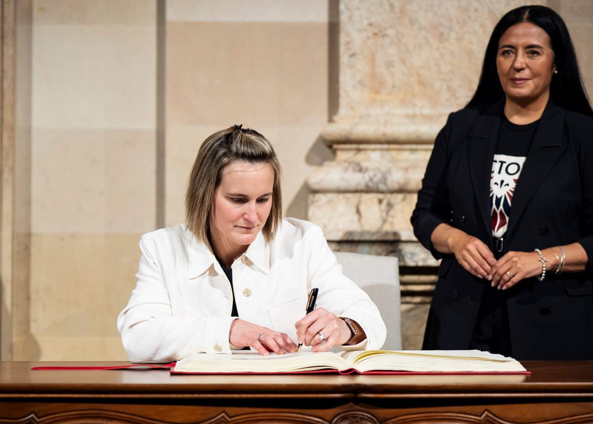 Montreal Victoire’s Marie-Philip Poulin is flanked by Montreal mayor Soraya Martinez Ferrada as she signs the golden book following the PWHL team’s Walter Cup victory, in Montreal on Tuesday, May 26, 2026.